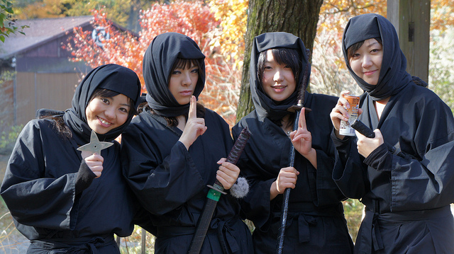 Girls dressed in ninja costumes and carrying weapons at Koka Ninja Village in Shiga Prefecture