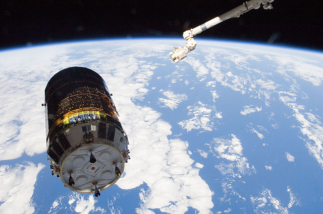 A Japanese HTV spacecraft and the robotic arm of the International Space Station