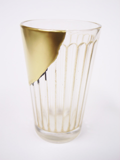 A glass that has had a large section replaced with gold-covered lacquer.