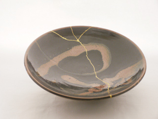 A plate by the Japanese potter Shoji Hamada that has been repaired with kintsukuroi