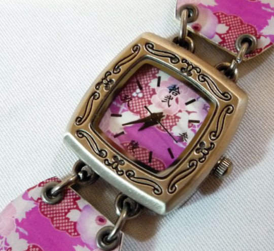 A watch with a pink Japanese flower design