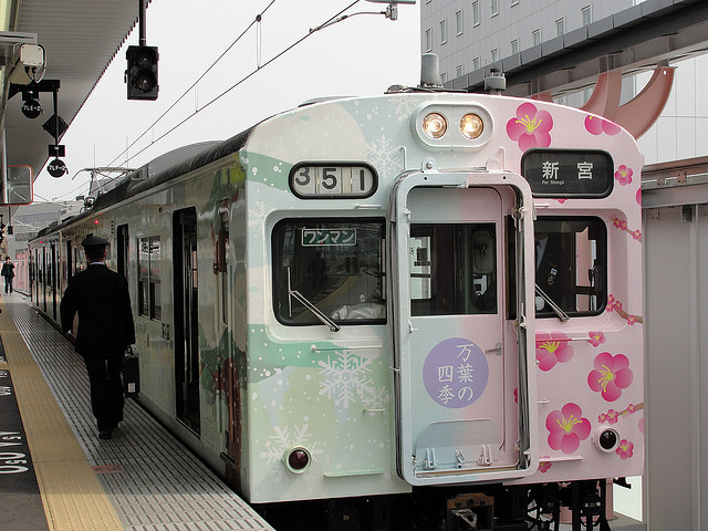 A train in Nara, Japan, painted with cherry blossoms and snow scenes