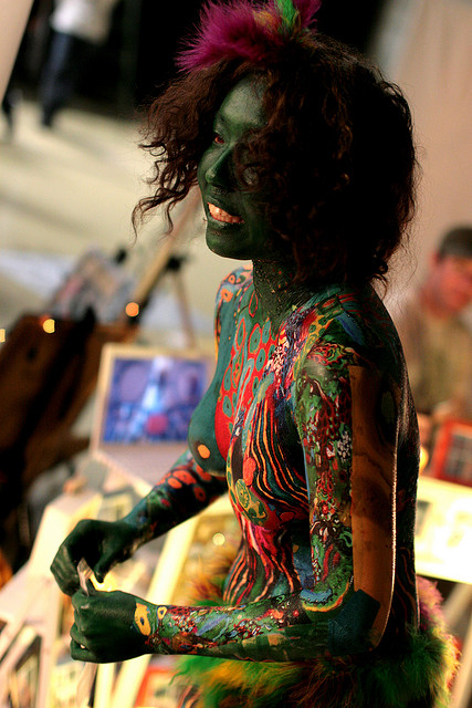 Body art at Design Festa: a woman who is painted all over in bright colours