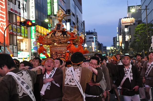 A portable Shinto shrine (a mikoshi) is carried through the streets of Akihabara in Tokyo as part of the Kanda Matsuri (神田祭)