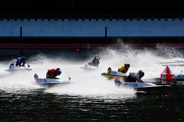 Six boats rounding a buoy during a kyotei race at Heiwajima Stadium in Tokyo