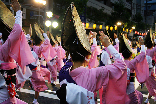 Women wearing pink yukata and straw hats performing the Awaodori dance in Koenji, Tokyo