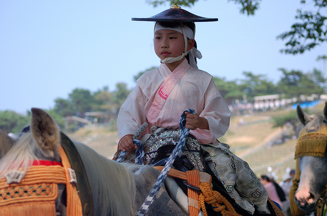 A child riding a horse at Soma Nomaoi