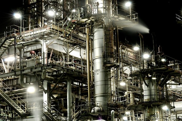 A network of stairs, ladders and access walkways attached to a chemical plant