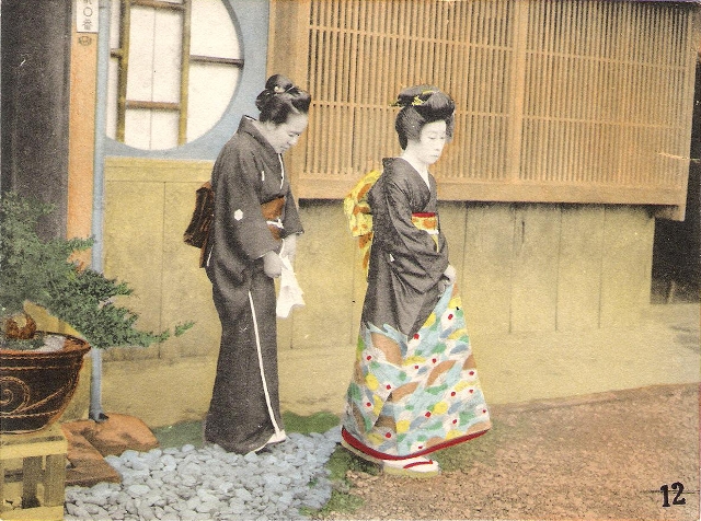 Two Japanese women in kimono, outside of a house