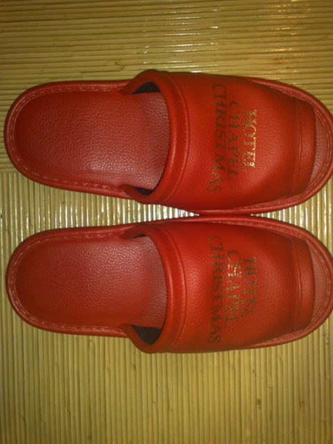A pair of ‘Hotel Chapel Christmas’ slippers