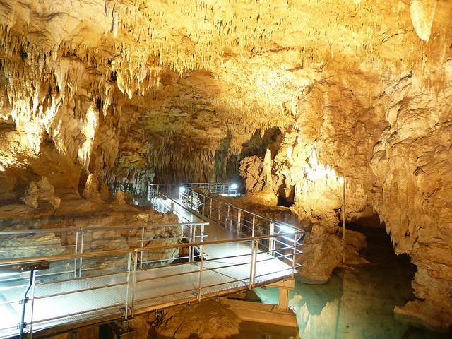 A walkway over water and under stalagmites at Gyokusendo Cave in Okinawa